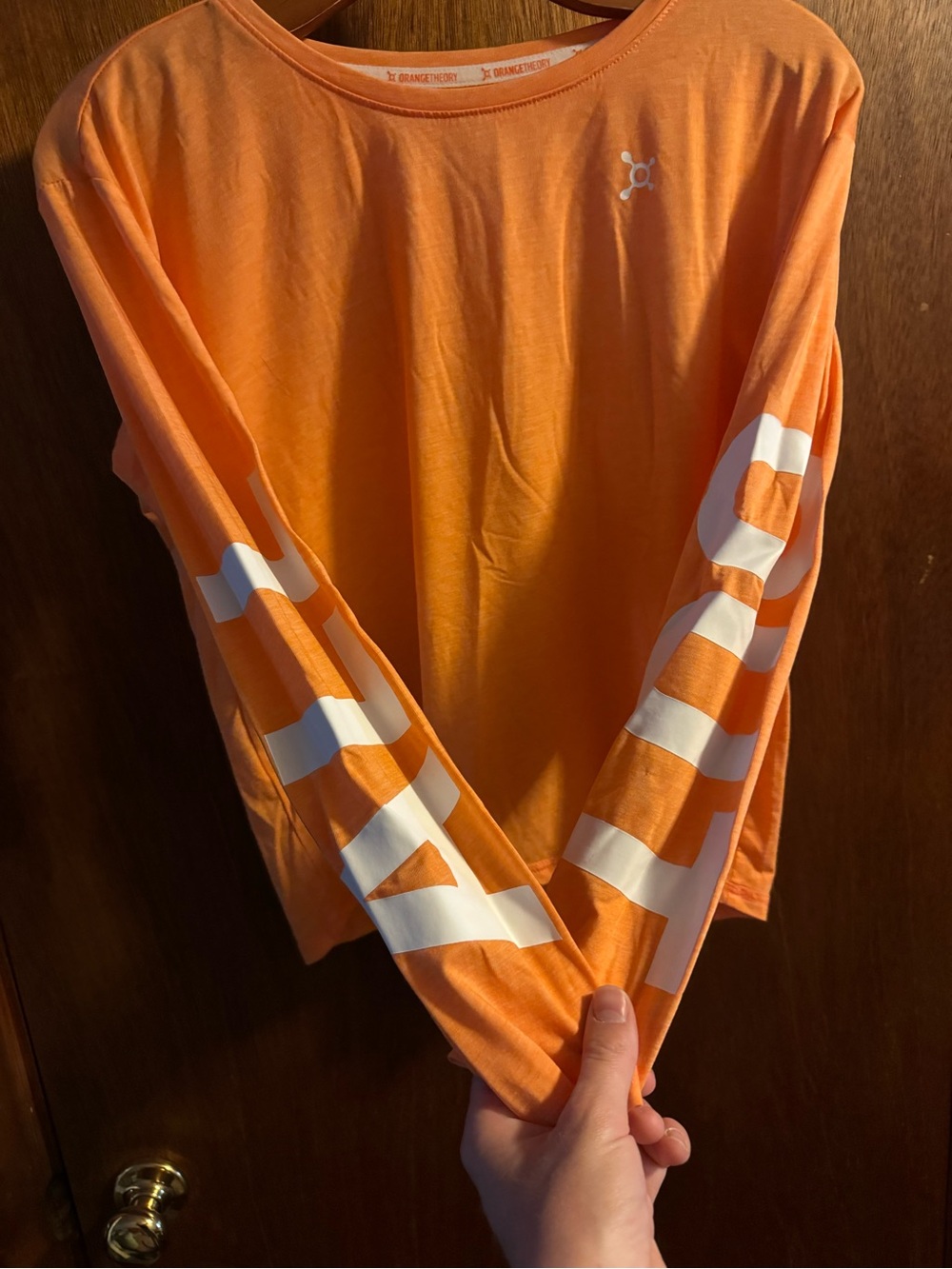 Orangetheory Orange Long Sleeve Logo Tee with White Sleeve “ALL OUT” Text